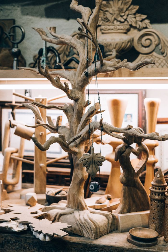 Services-03 Wooden sculptures and carvings arranged in an artisan's workshop, showcasing craftsmanship.