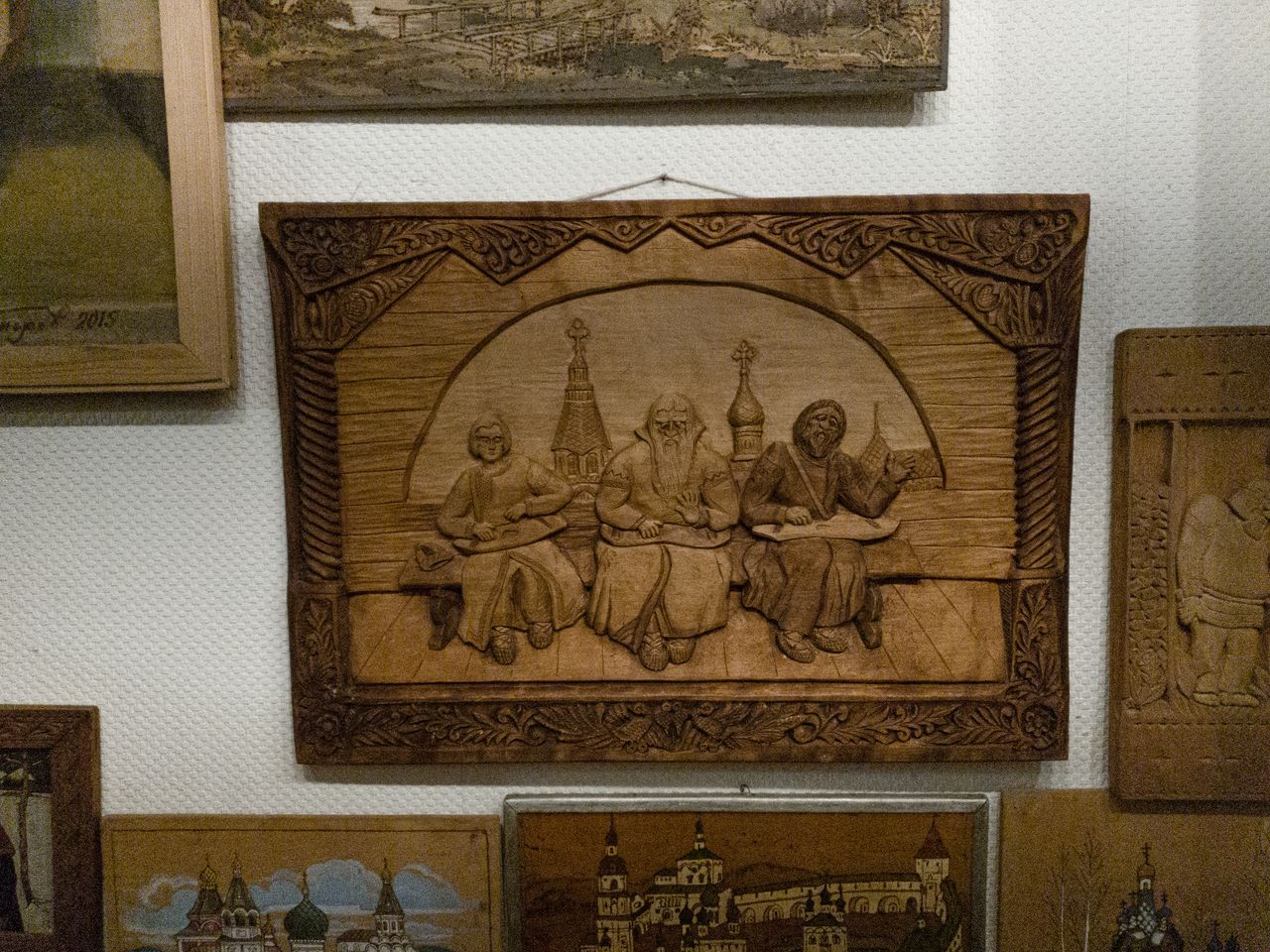 mobile-01 Detailed bas relief artwork on display in a museum, showcasing wood craftsmanship.