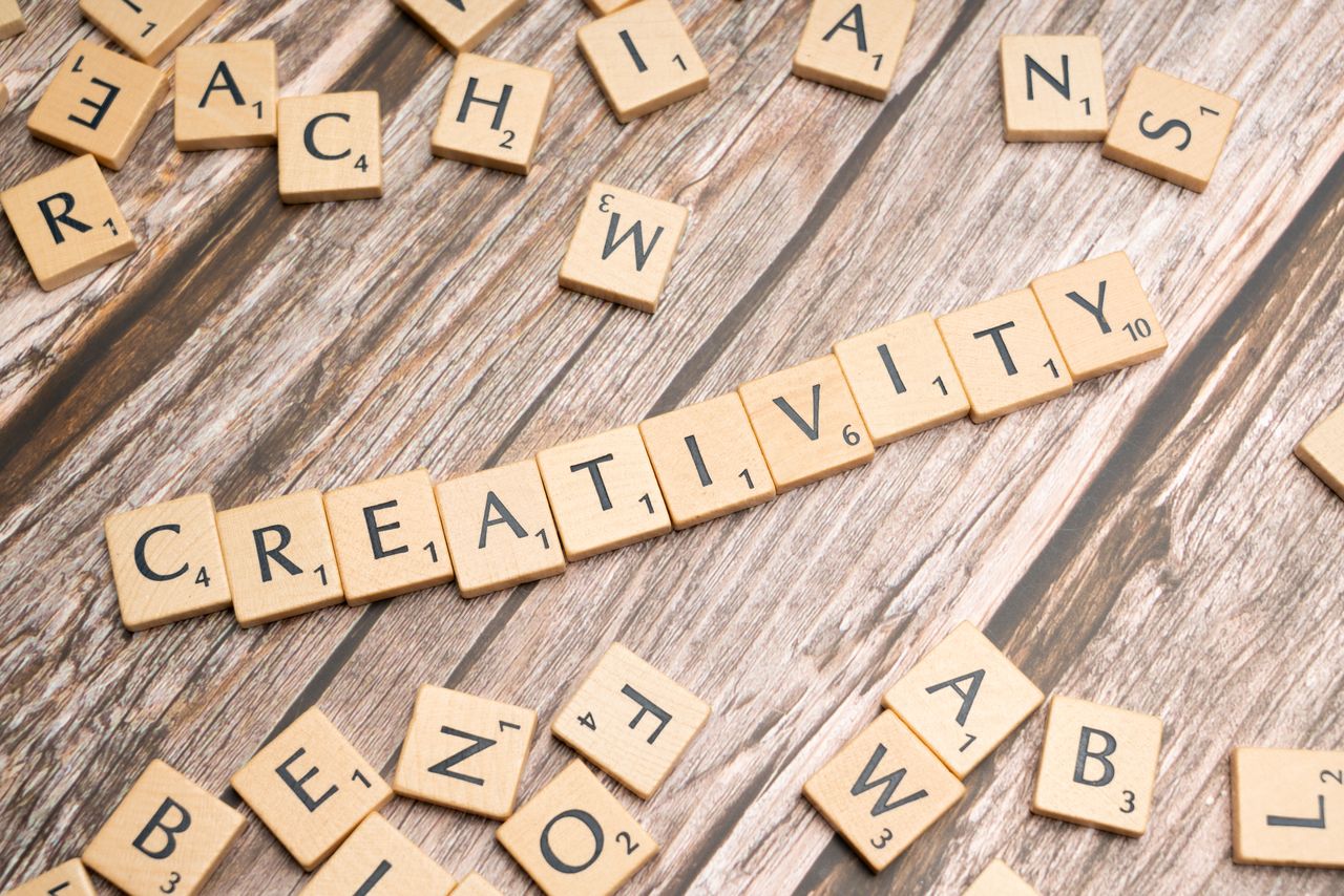 digital-01 Wooden letter tiles spelling 'creativity' on a rustic wooden background.